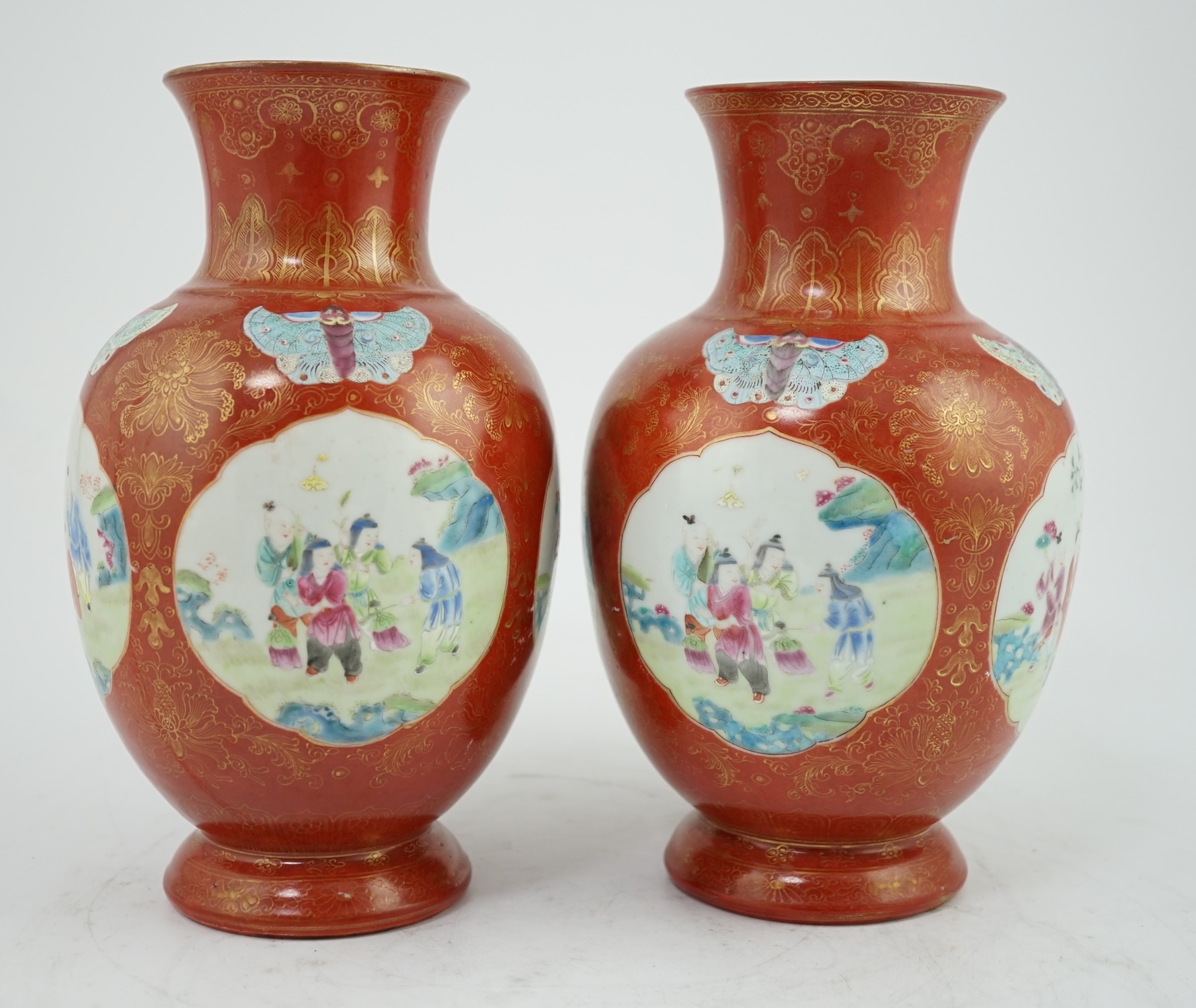 A pair of Chinese coral ground ‘boys’ vases, Jiaqing period (1796-1820)